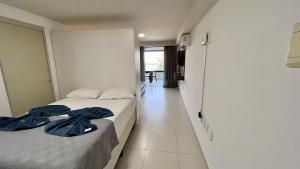 Ένα ή περισσότερα κρεβάτια σε δωμάτιο στο Flat Frente Mar - Praia de Tabatinga