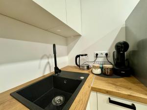 a kitchen with a sink and a counter top at UAB DU PROCENTAI nt in Šiauliai