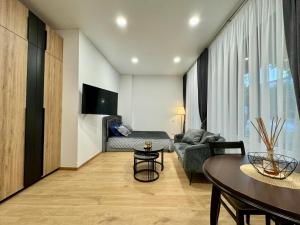 a living room with a couch and a table at UAB DU PROCENTAI nt in Šiauliai