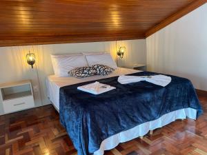 a bedroom with a bed with two towels on it at Lofts do Pilar - pousada in Ouro Preto +35 photos