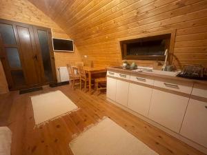 a kitchen and dining room with a table and a television at Livada Luxurious Bungalow in Livada