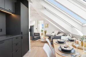 a kitchen and living room with a table and chairs at Great and modern apartment with wifi and new furniture in Haugesund