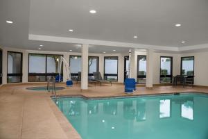 a large pool with blue water in a building at Courtyard Lafayette Airport in Lafayette