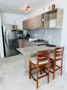 Kuchyň nebo kuchyňský kout v ubytování Aria ocean frente ala playa alberca infinita