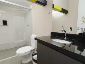 a bathroom with a white toilet and a sink at Apê Paulista Augusta in São Paulo +51 photos