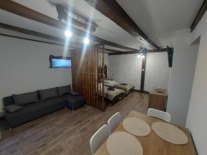 a living room with a table and a couch at Belvárosi apartmanház 2, Apartman 3 in Szigetvár