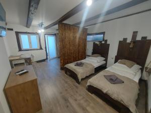 a large room with two beds and a table at Belvárosi apartmanház 2, Apartman 3 in Szigetvár