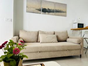 a couch in a living room with two pictures on the wall at Clemens9 Premium in Málaga