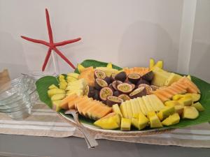 a plate filled with different types of food on a table at Hotel Perla in Castiglione della Pescaia
