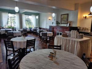 a dining room with tables and chairs and tablesearcher at Filadélfia Hospedagens e Eventos in São Bento do Sul