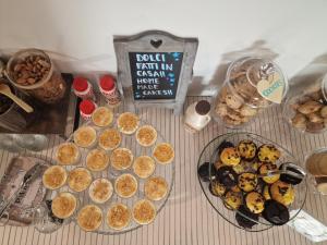 a table topped with plates of cookies and pastries at Hotel Perla in Castiglione della Pescaia