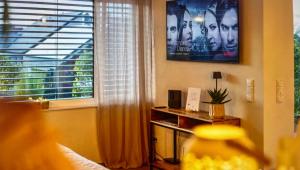 a living room with a large window and a movie poster at Ferienhaus Casa Deluxe Dockweiler Eifel in Dockweiler
