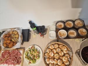 a table with plates of food and a bottle of beer at Hotel Perla in Castiglione della Pescaia
