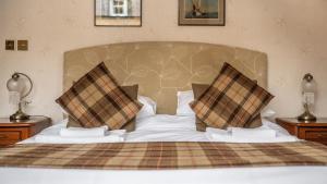 a large bed with two pillows on top of it at The Old Bank House Self Catering Apartment Dornoch in Dornoch +11 photos