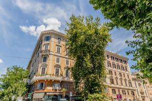 a tall building with a tree in front of it at Vatican Sweet Guest House in Rome