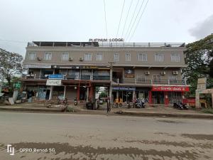 a large building on the side of a street at Platinum Lodge in Sibsāgar