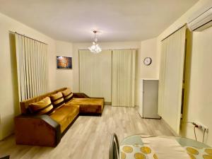 a living room with a couch and a table at Ssenyange Sea View Apartment in Varna City