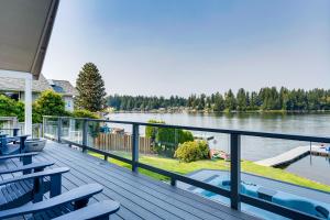 a deck with chairs and a view of a lake at The Rookery - Dreamy Home with Private Dock! in Yelm