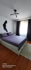 a bed in a bedroom with a person jumping on it at Serghi in Mangalia