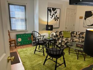 a living room with a couch and chairs and a table at Welcome to Camp Sycamore in Pittsburgh