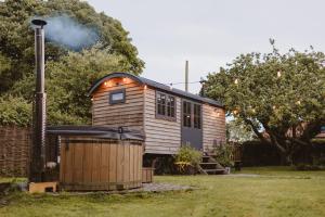 a tiny house in a yard with smoke coming out of it at The Starlight Hideaway in Hull