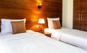 Postel nebo postele na pokoji v ubytování Britannia Suites