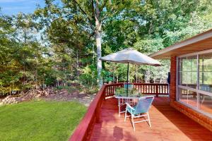 a porch with a table and chairs and an umbrella at Lakeview Getaway in Lakeview