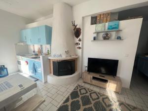 a living room with a tv and a fireplace at Lovely sea apartment Amarynthos in Amarinthos +13 photos