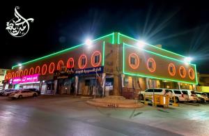 a building with cars parked in a parking lot at night at دره الرياض للشقق الفندقيه in Riyadh