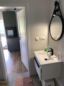 a white bathroom with a sink and a mirror at Domek Adam in Macharce +13 photos