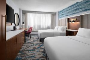 a hotel room with two beds and a desk at DoubleTree by Hilton Hartford Downtown in Hartford