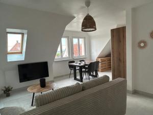 a living room with a couch and a table at Nuits en Alsace in Morsbronn-les-Bains