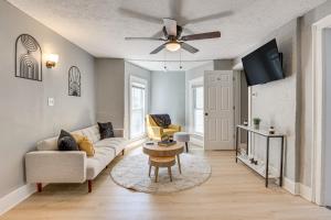 a living room with a couch and a ceiling fan at University of Akron Retreat Dogs Welcome! in Akron