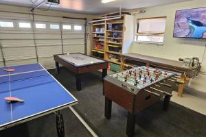 two ping pong tables in a room with a chessboard at Cliff Views - Hot Tub - SUPs - Boat Parking - Sleeps 16 in Page