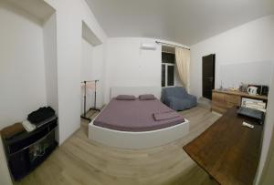 a bedroom with a bed in the middle of a room at Apart 26 in Odesa