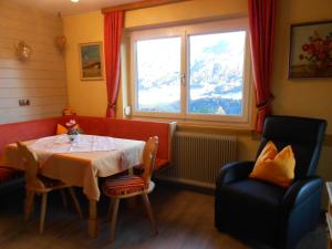 a dining room with a table and a window at Haus Leitgeb in Telfes im Stubai