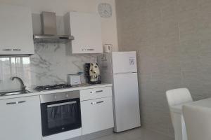 a kitchen with white appliances and a white refrigerator at Cavour3 in Nettuno