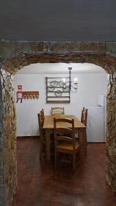 a dining room with a table and a refrigerator at Casa da Milharica in Figueiró dos Vinhos