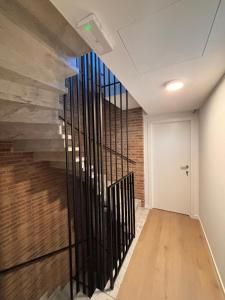 a hallway with a staircase with a brick wall at Business Accommodation 'Flow Living' Nomad in Geel +10 photos
