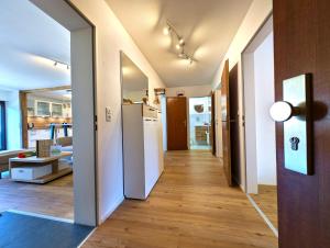 a hallway leading to a kitchen and a living room at Ferienwohnung Alpenglut in Nesselwang +25 photos