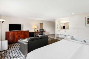 a hotel room with a bed and a television at SureStay Hotel by Best Western Manchester in Manchester