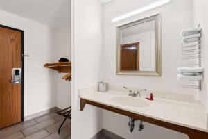 a bathroom with a sink and a mirror at SureStay Hotel by Best Western Manchester in Manchester +21 photos