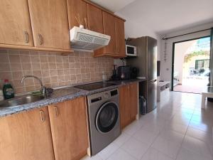 a kitchen with a washing machine and a sink at Castillo Mar - 82 in Caleta De Fuste