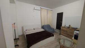 a bedroom with a bed and a desk and a chair at Apart 26 in Odesa
