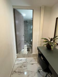 a bathroom with a mirror and a desk and a shower at La Puerta Blanca #2 in Puerto Vallarta