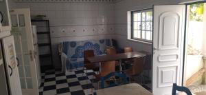a dining room with a table and chairs at Quarto privado 5 in Famões +8 photos