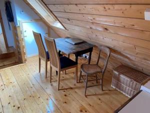 a dining room with a wooden table and chairs at Airebroc Byre in Uig