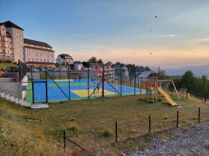 a park with a playground with a slide at N-delux apartman in Kopaonik