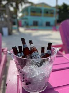 a bucket of beer bottles sitting on a table at Barefoot Beach Belize in Caye Caulker