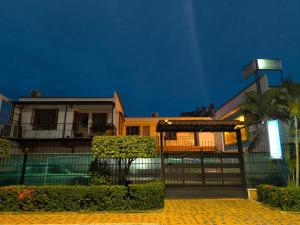 a house with a gate in front of it at night at Hotel Palmarito in Tauramena